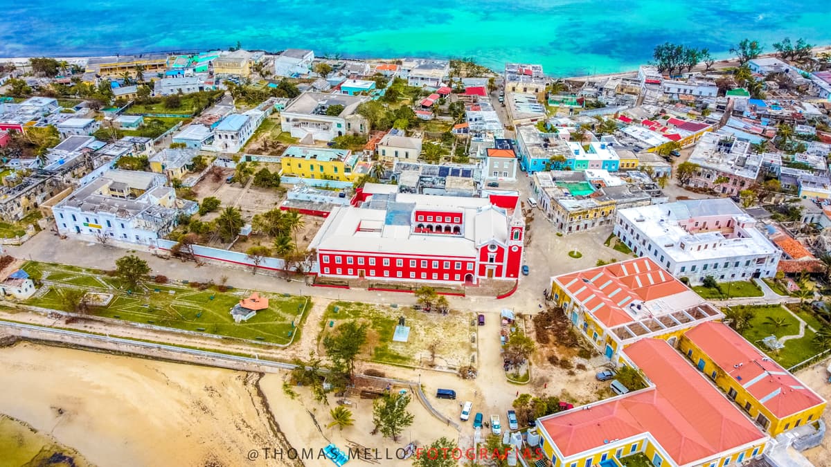 Aerial view of Ilha de Moçambique: colonial buildings, a red church and turquoise sea
