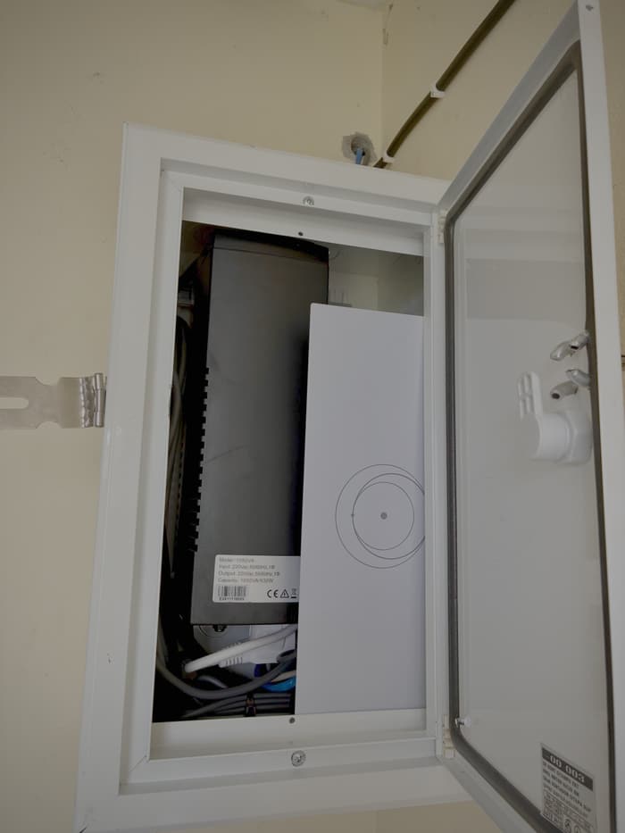 Starlink router installed inside a white weatherproof enclosure